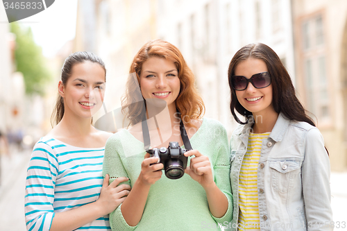 Image of smiling teenage girls with camera