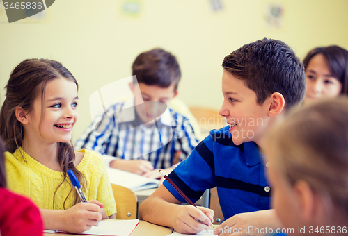 Image of group of school kids writing test in classroom