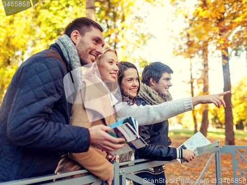 Image of group of friends with map outdoors