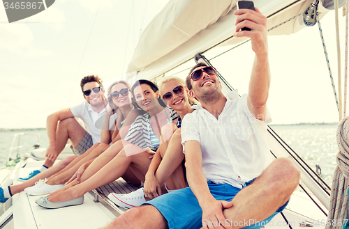 Image of smiling friends sitting on yacht deck