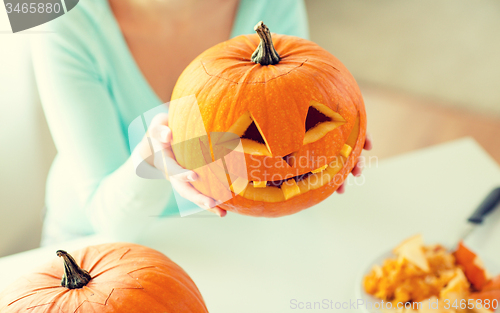 Image of close up of woman with pumpkins at home