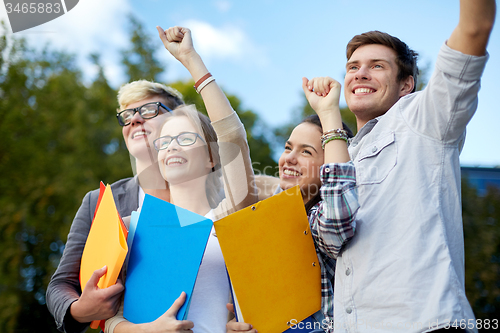 Image of group of happy students showing triumph gesture