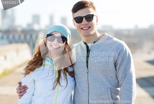 Image of happy teenage couple walking in city