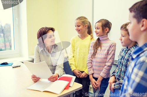 Image of group of school kids with teacher in classroom