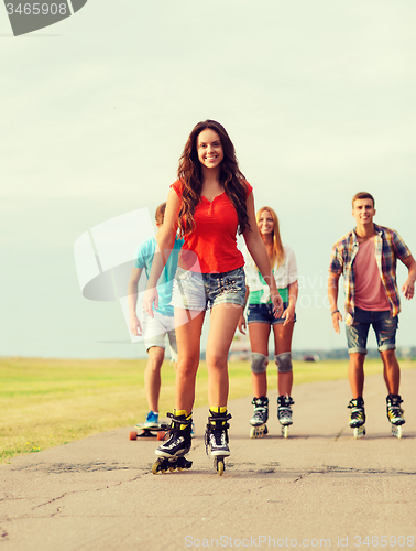 Image of group of smiling teenagers with roller-skates