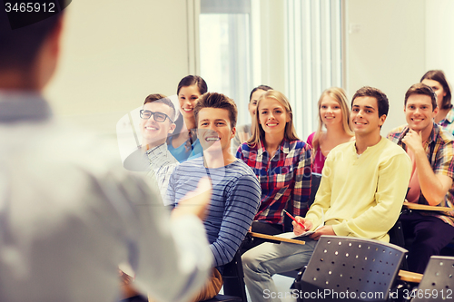 Image of group of students and teacher with notebook