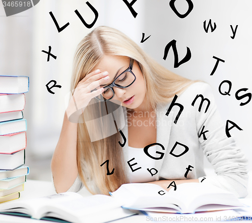 Image of student with books and notes