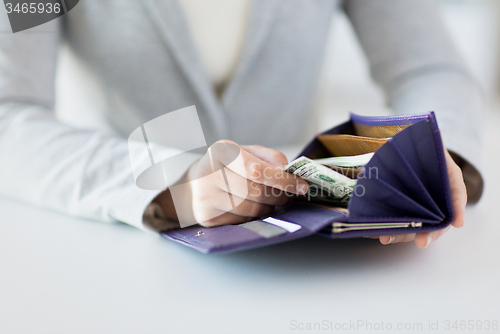 Image of close up of woman hands with wallet and money