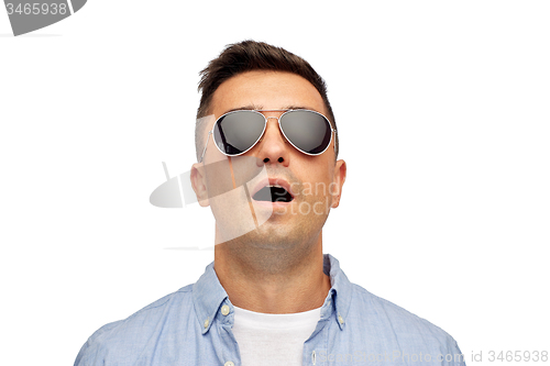 Image of face of scared man in shirt and sunglasses