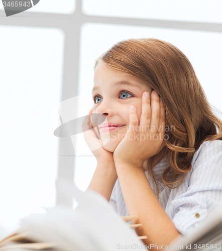 Image of student girl writing in notebook at school