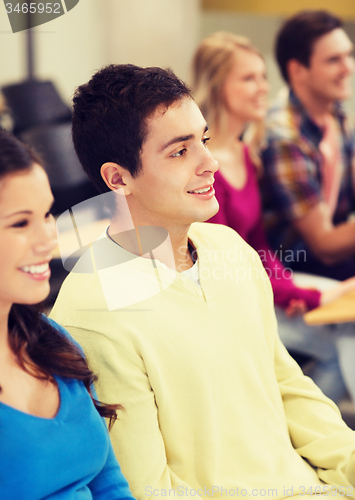 Image of group of smiling students in lecture hall