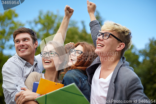 Image of group of happy students showing triumph gesture
