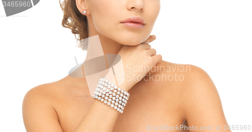 Image of woman with pearl earrings and bracelet