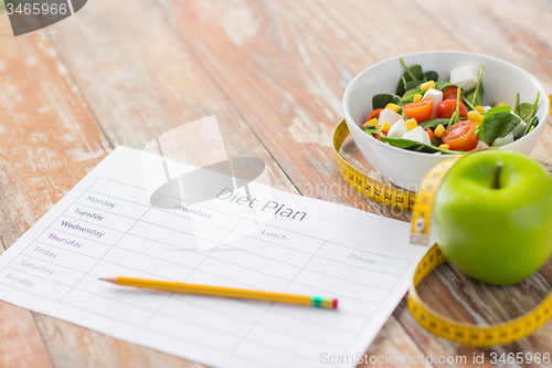 Image of close up of diet plan and food on table