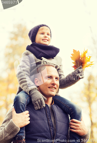 Image of happy family having fun in autumn park