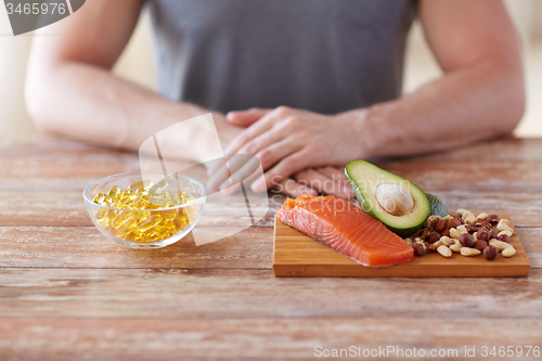 Image of close up of male hands with food rich in protein