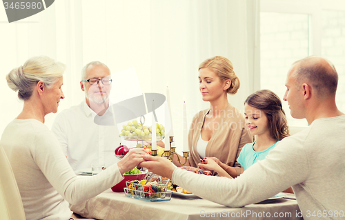 Image of smiling family having holiday dinner at home