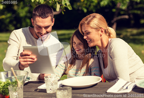 Image of happy family with tablet pc outdoors