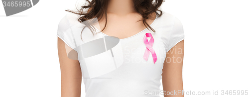 Image of smiling woman with pink cancer awareness ribbon