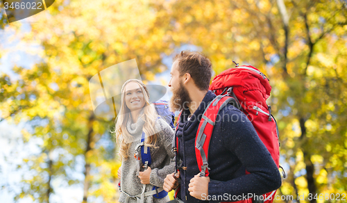 Image of smiling couple with backpacks hiking