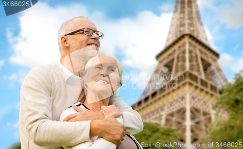 Image of happy senior couple over paris eiffel tower