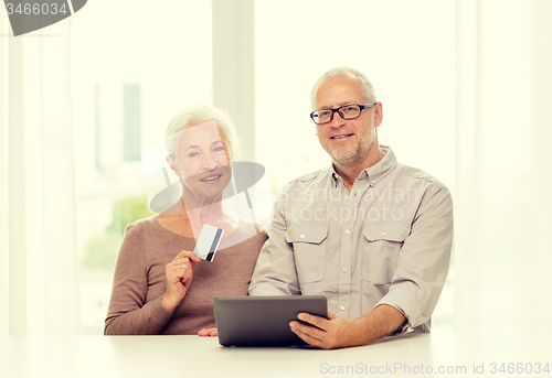Image of happy senior couple with tablet pc and credit card