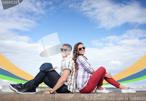 Image of teenagers sitting back to back