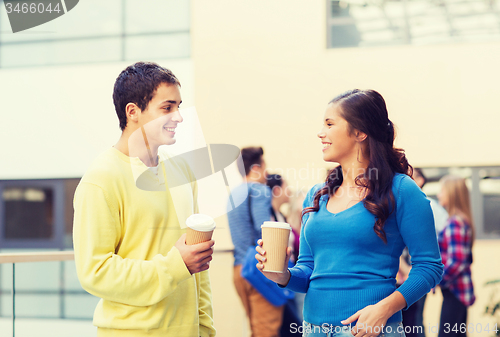 Image of group of smiling students with paper coffee cups