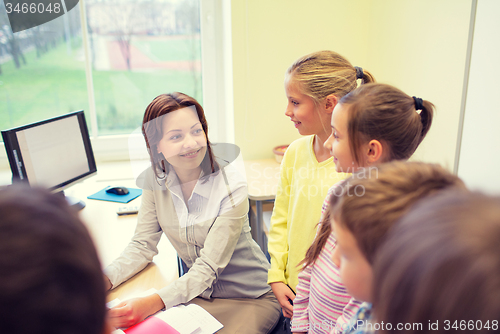 Image of group of school kids with teacher in classroom