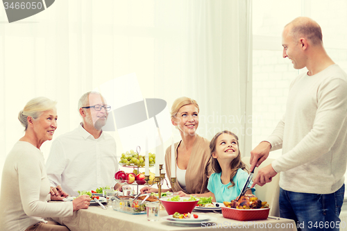 Image of smiling family having holiday dinner at home