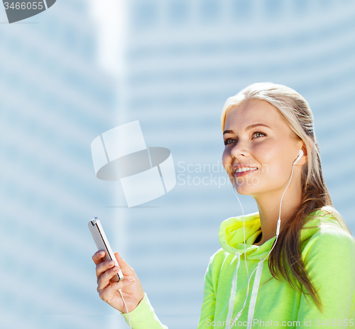 Image of woman listening to music outdoors