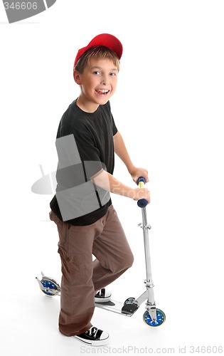 Image of Boy standing beside a scooter