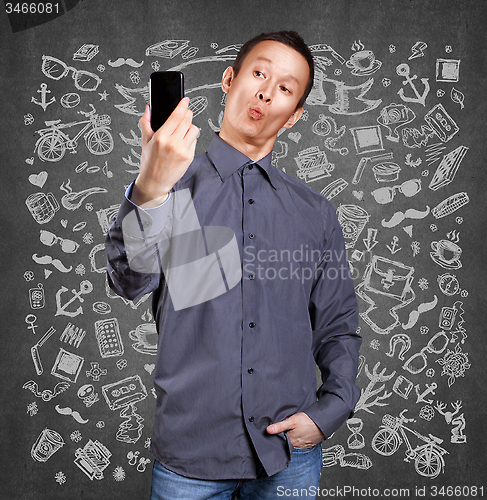 Image of Asian Man Making A Selfie