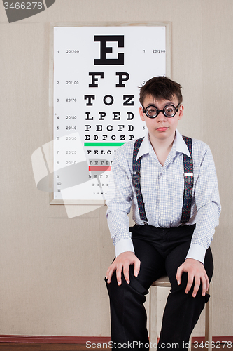 Image of person wearing spectacles in an office at the doctor