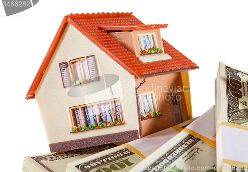 Image of house on packs of banknotes