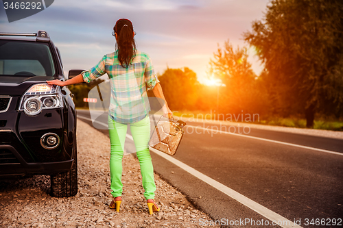 Image of Woman with an empty tank of gas