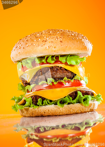 Image of Tasty and appetizing hamburger on a yellow