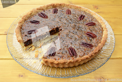 Image of Pecan pie on a plate with one slice taken