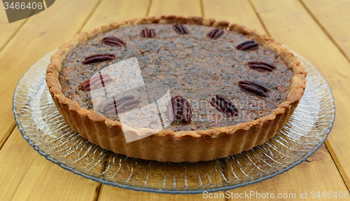 Image of Freshly baked pecan pie on a glass plate