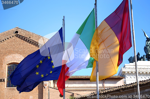 Image of Flags of Italy, European Union and Roma city waving in Rome, Ita