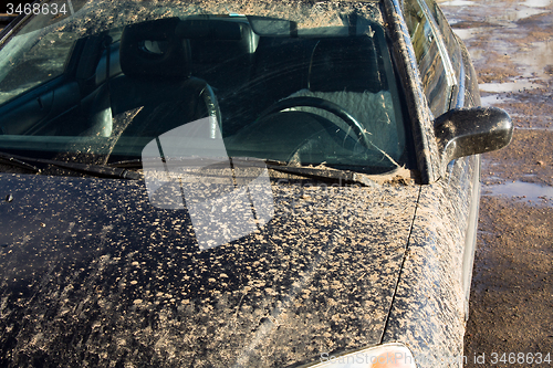 Image of black car in mud.