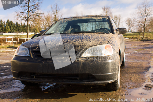 Image of black car in mud.