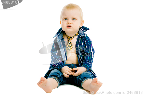 Image of Little dissatisfied boy in a plaid shirt