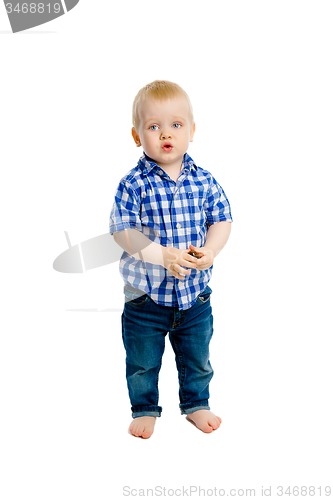 Image of little boy in a plaid shirt and jeans