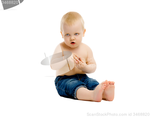 Image of little boy in a jeans on white