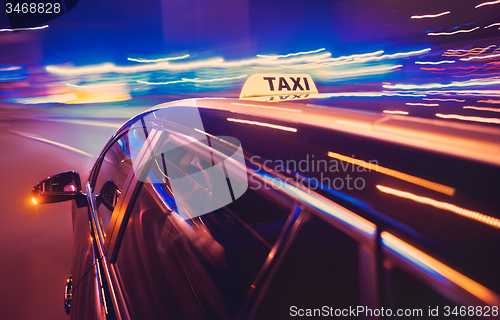 Image of Taxi taking a left turn at night