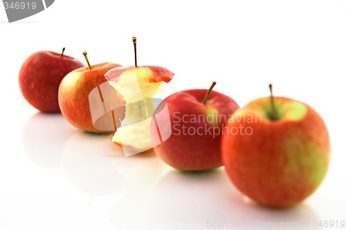 Image of Apple core among whole apples, focus on the core