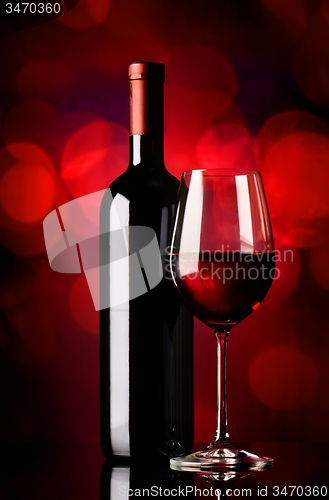 Image of Bottle with wine on red