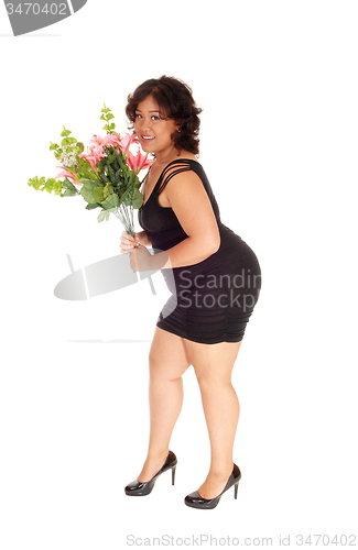 Image of Happy mixed race woman with flowers.