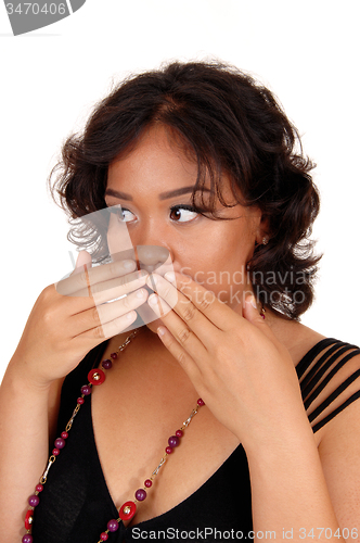 Image of Woman holding her hand on mouth.